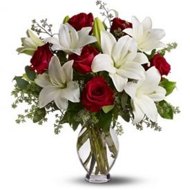 Bunch of red roses and white lilies with vase