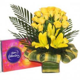 Yellow flowers and chocolates with vase